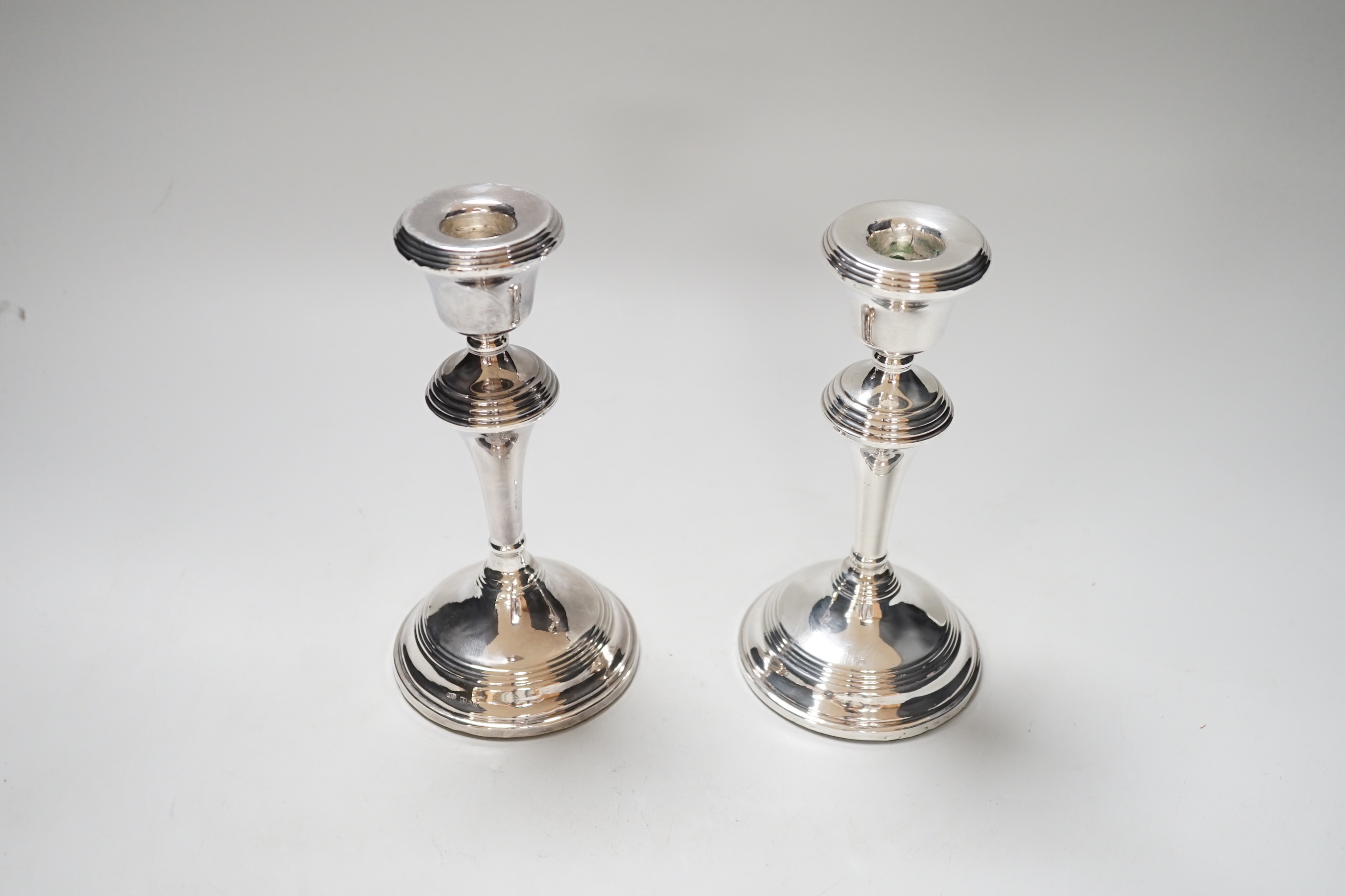 A pair of Elizabeth II silver candlesticks, loaded, Birmingham 1959, 17.5cm